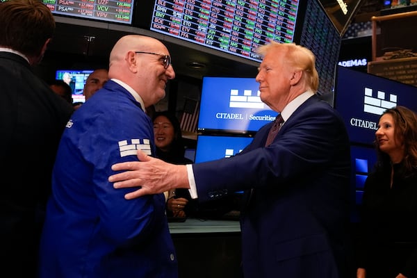 President-elect Donald Trump speaks with trader Peter Giacchi, as he walks the floor of the New York Stock Exchange, Thursday, Dec. 12, 2024, in New York. (AP Photo/Alex Brandon)