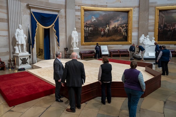 Officials inspect the construction of a stand in the Rotunda, where President-elect Donald Trump is due to take the oath of office on Monday, at the Capitol in Washington, Friday, Jan. 17, 2025. (AP Photo/Ben Curtis)