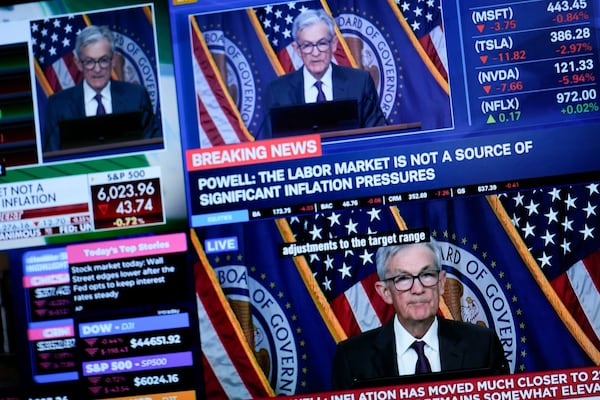 Screens display a news conference by Federal Reserve Chair Jerome Powell on the floor of the New York Stock Exchange in New York, Wednesday, Jan. 29, 2025. (AP Photo/Seth Wenig)