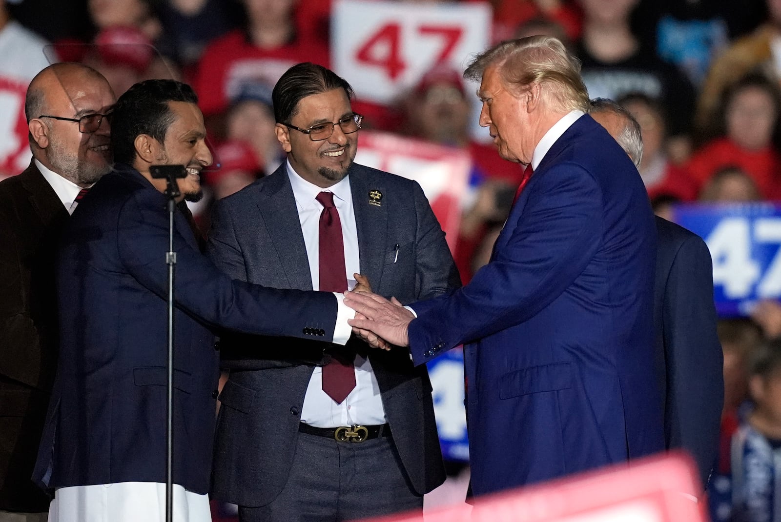 Republican presidential nominee former President Donald Trump, right, greet local Muslim leaders during a campaign rally at the Suburban Collection Showplace, Saturday, Oct. 26, 2024 in Novi, Mich. (AP Photo/Carlos Osorio)