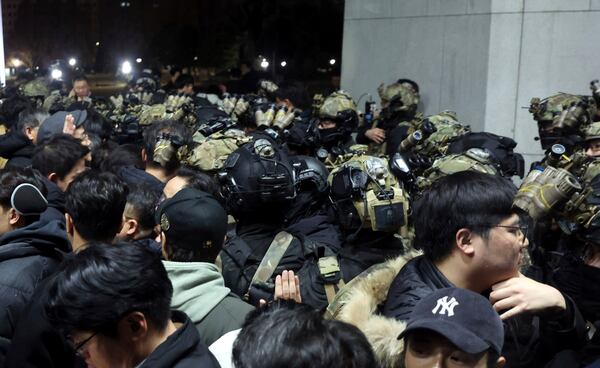 South Korean martial law soldiers try to enter the National Assembly compound in Seoul, South Korea, Wednesday, Dec. 4, 2024. (Cho Sung-bong/Newsis via AP)