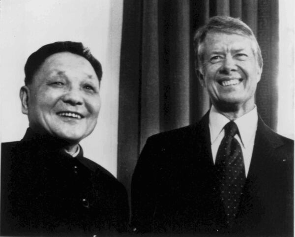 FILE - Chinese Vice Premier Deng Xioaping and President Jimmy Carter smile as they face photographers in the Oval Office in Washington on Jan. 29, 1979. (AP Photo, File)