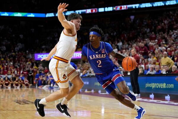 Kansas guard AJ Storr (2) drives past Iowa State guard Nate Heise (0) during the first half of an NCAA college basketball game Wednesday, Jan. 15, 2025, in Ames, Iowa. (AP Photo/Charlie Neibergall)