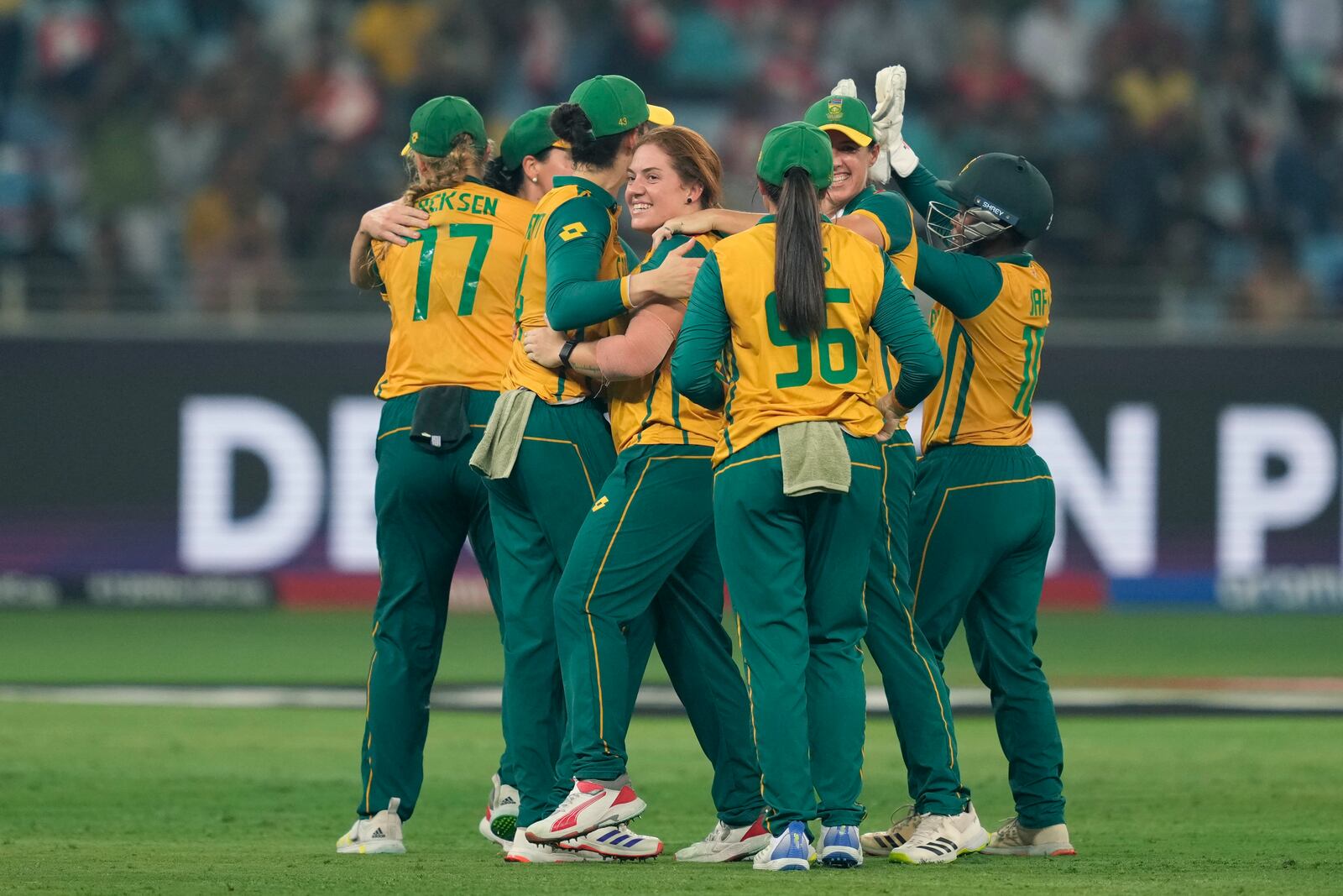 South Africa's Nadine de Klerk, center, without a cap, celebrates with teammates the wicket of New Zealand's captain Sophie Devine during the ICC Women's T20 World Cup 2024 final match between New Zealand and South Africa at Dubai, United Arab Emirates, Sunday, Oct. 20, 2024. (AP Photo/Altaf Qadri)