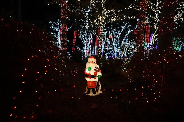 A Santa decoration is seen among holiday lights at the Lights of Joy display Monday, Dec. 16, 2024, in Kennesaw, Ga. (AP Photo/Brynn Anderson)