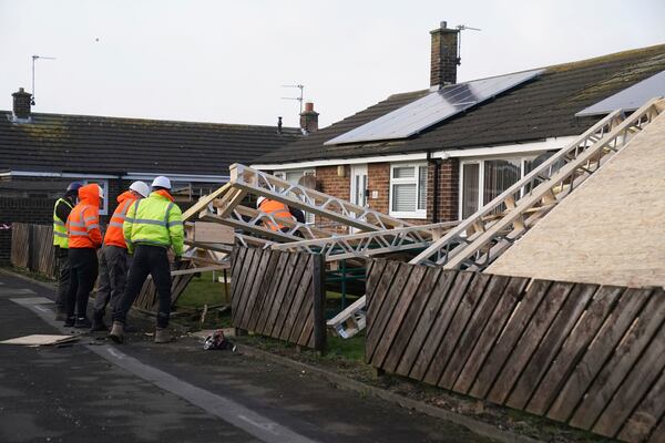 A roof blown off during strong winds rests on some bungalows in Amble, Northumberland, in the North East of England, as Storm Eowyn hits the country, on Friday Jan. 24, 2025. (Owen Humphreys/PA via AP)