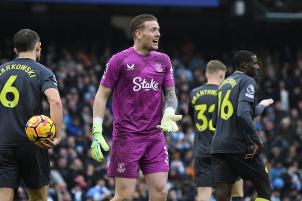 Everton's goalkeeper Jordan Pickford, center, reacts after saving a penalty kick by Manchester City's Erling Haaland during the English Premier League soccer match between Manchester City and Everton at the Etihad stadium in Manchester, Thursday, Dec. 26, 2024. (AP Photo/Rui Vieira)