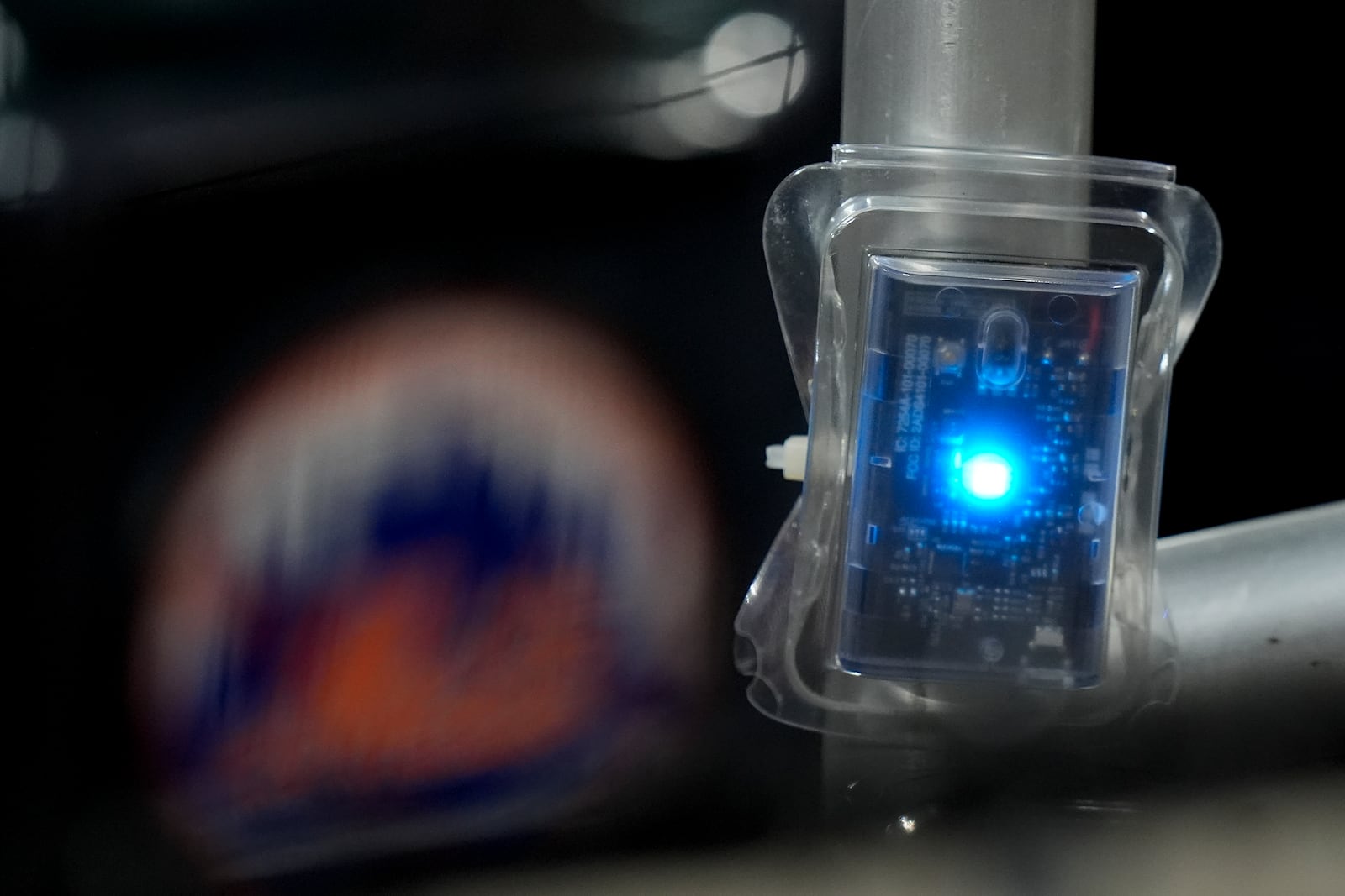 A blue LED light hangs from a railing in the grandstand during Game 4 of the National League baseball playoff series between the New York Mets and the Philadelphia Phillies, Wednesday, Oct. 9, 2024, in New York. (AP Photo/Frank Franklin II)