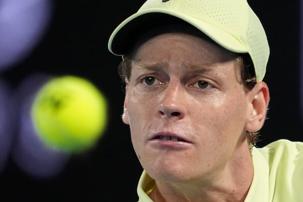 Jannik Sinner of Italy plays a backhand return to Ben Shelton of the U.S. during their semifinal match at the Australian Open tennis championship in Melbourne, Australia, Friday, Jan. 24, 2025. (AP Photo/Ng Han Guan)