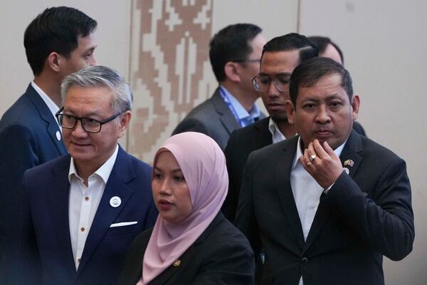 Laos's Minister of Foreign Affairs Thongsavanh Phomvihane, second from left, and Myanmar's Permanent Secretary to ASEAN Aung Kyaw Moe, right, attend the ASEAN Foreign Ministers' Retreat (AMM) in Langkawi Island, Malaysia, on Sunday, Jan. 19, 2025. (AP Photo/Azneal Ishak, Pool)