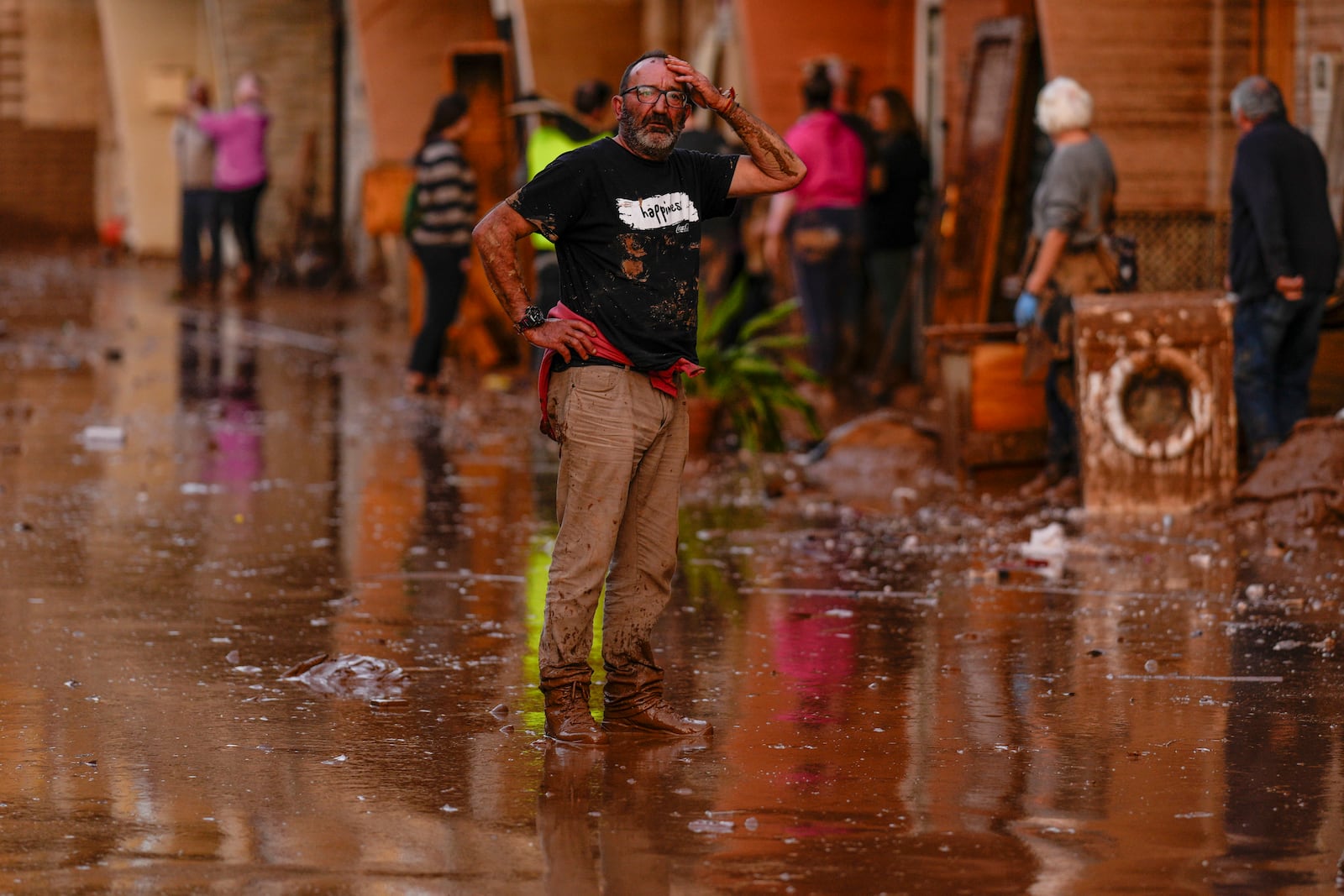 A man reacts in front of houses affected by floods in Utiel, Spain, Wednesday, Oct. 30, 2024. (AP Photo/Manu Fernandez)