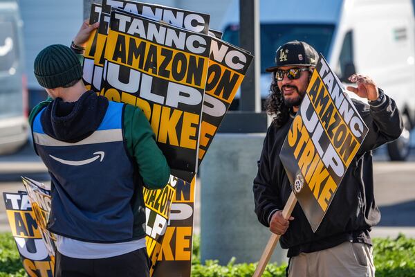 Amazon workers strike outside the gates of an Amazon Fulfillment Center as Teamsters seek labor contract nationwide, Thursday, Dec. 19, 2024, in City of Industry, Calif. (AP Photo/Damian Dovarganes)