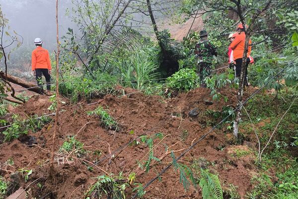 In this undated photo released by Indonesia's National Disaster Management Agency (BNPB) on Wednesday, Jan. 22, 2025, rescuers search for the victims of flash flood which triggered a landslide, in Pekalongan, Central Java, Indonesia. (BNPB via AP)