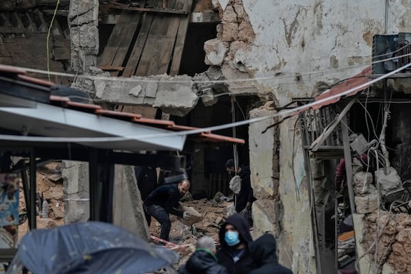 People inspect a destroyed building hit on Monday evening by an Israeli airstrike in central Beirut, Lebanon, Tuesday, Nov. 19, 2024. (AP Photo/Bilal Hussein)