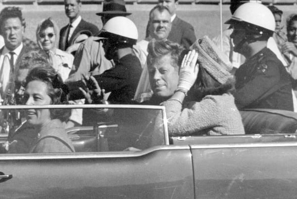 FILE - President John F. Kennedy waves from his car in a motorcade in Dallas, with first lady Jacqueline Kennedy, right, Nellie Connally, second from left, and her husband, Texas Gov. John Connally, far left, Nov. 22, 1963. (AP Photo/Jim Altgens, File)