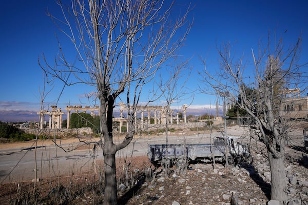 Damaged vehicles are seen in front of the Roman temples of Baalbek in eastern Lebanon, Thursday, Nov. 28, 2024. (AP Photo/Hassan Ammar)