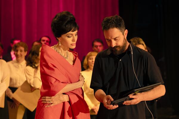 This image released by Netflix shows Angelina Jolie, left, with director Pablo Larraín on the set of "Maria." (Pax Jolie-Pitt//Netflix via AP)