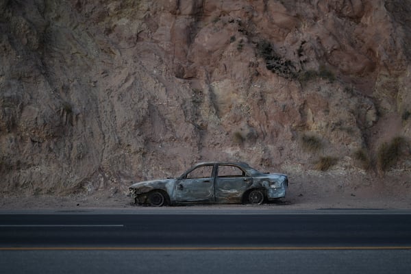 A car destroyed by the Palisades Fire sits on the side of a road Friday, Jan. 10, 2025, in Malibu, Calif. (AP Photo/Eric Thayer)