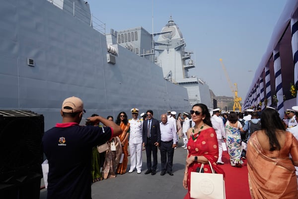 Indian naval officers takes pictures after the commissioning ceremony of a submarine, a destroyer and a frigate built at a state-run shipyard in Mumbai, India, Wednesday, Jan. 15, 2025. (AP Photo/Rafiq Maqbool)