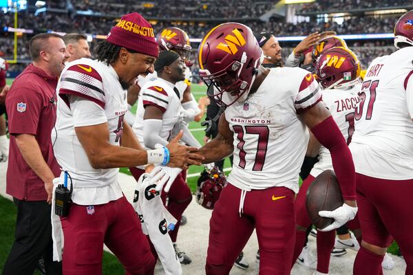 Washington Commanders wide receiver Terry McLaurin (17) celebrates after scoring a touchdown with quarterback Jayden Daniels during the second half of an NFL football game against the Dallas Cowboys, Sunday, Jan. 5, 2025, in Arlington, Texas. The Commanders won 23-19. (AP Photo/Josh McSwain)