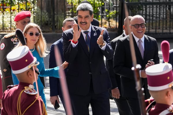 Venezuelan President Nicolas Maduro, center, his wife Cilia Flores, left, and National Assembly President Jorge Rodriguez arrive at the National Assembly for Maduro's swearing-in ceremony for a third term in Caracas, Venezuela, Friday, Jan. 10, 2025.(AP Photo/Matias Delacroix)