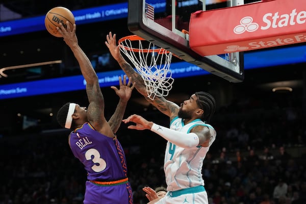 Phoenix Suns guard Bradley Beal (3) goes up to shoot over Charlotte Hornets center Nick Richards (4) during the second half of an NBA basketball game Sunday, Jan. 12, 2025, in Phoenix. (AP Photo/Ross D. Franklin)