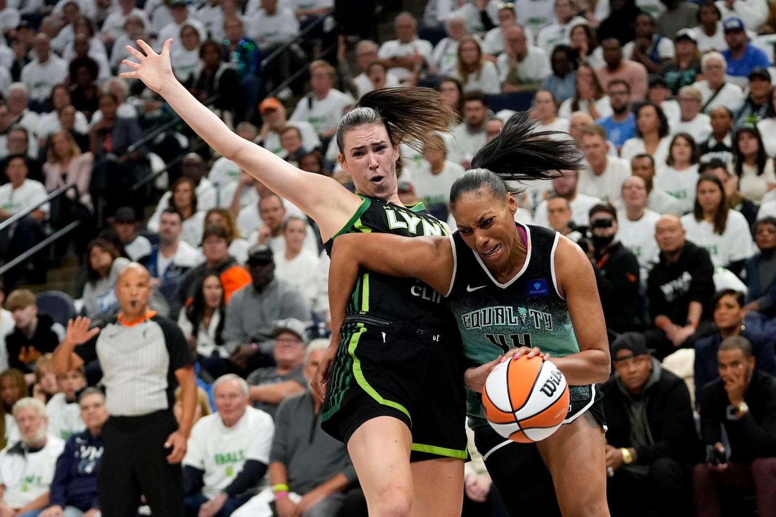 Minnesota Lynx forward Bridget Carleton, left, is fouled by New York Liberty forward Betnijah Laney-Hamilton (44) during the first half in Game 3 of a WNBA basketball final playoff series, Wednesday, Oct. 16, 2024, in Minneapolis. (AP Photo/Abbie Parr)