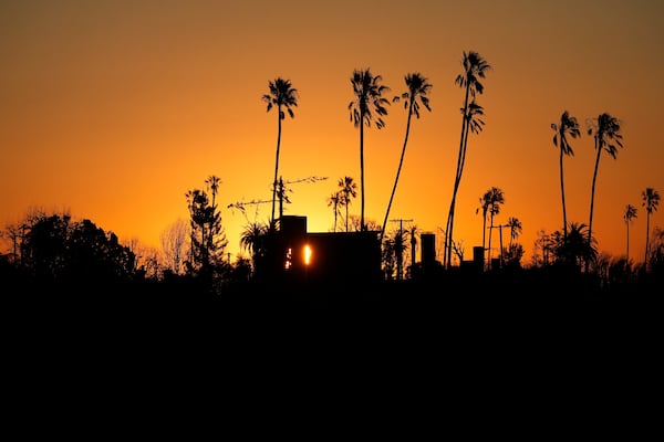 The Sun rises over homes destroyed by the Palisades Fire in the Pacific Palisades neighborhood of Los Angeles, Thursday, Jan. 16, 2025. (AP Photo/Damian Dovarganes)