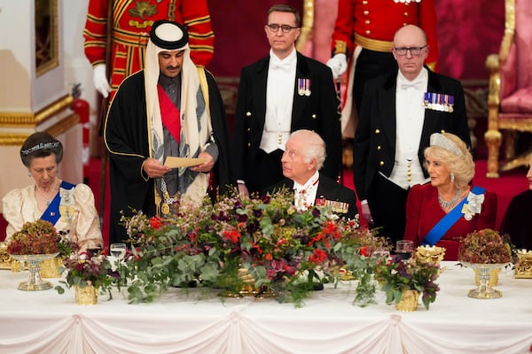 Britain's King Charles III, centre, and Queen Camilla, right, with the Emir of Qatar Sheikh Tamim bin Hamad Al Thani, second left, and Britain's Princess Anne, left, during a State Banquet at Buckingham Palace, in London, Tuesday, Dec. 3, 2024, during the state visit to the U.K. of the Emir of Qatar and the first of his three wives. (Jordan Pettitt/Pool Photo via AP)