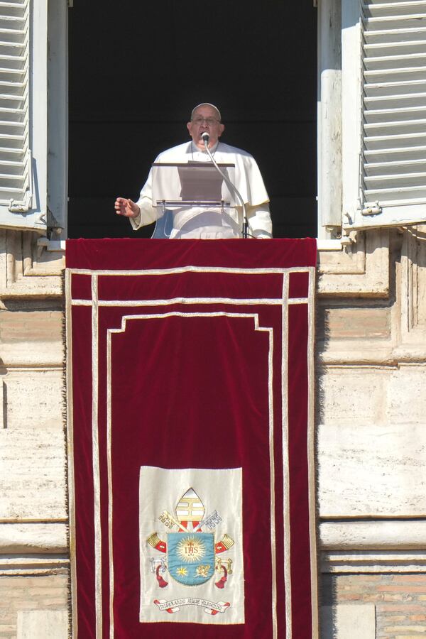 Pope Francis appears at his studio's window overlooking St. Peter's Square at The Vatican to bless pilgrims and faithful after presiding over a mass in St. Peter's Basilica on New Year's Day, Wednesday, Jan. 1, 2025. (AP Photo/Andrew Medichini)