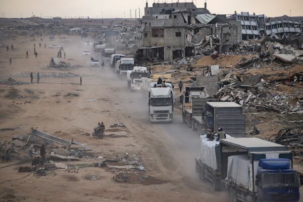 Humanitarian aid trucks enter through the Kerem Shalom crossing from Egypt into the Gaza Strip, in Rafah, Wednesday, Jan. 22, 2025, days after the ceasefire deal between Israel and Hamas came into effect. (AP Photo/Jehad Alshrafi)