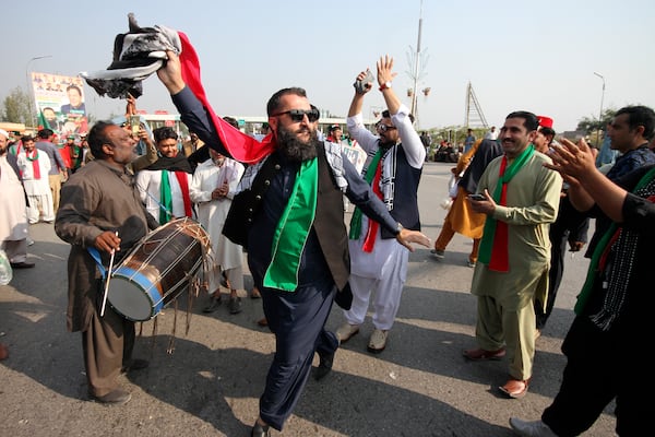 Supporters of imprisoned former premier Imran Khan's Pakistan Tehreek-e-Insaf party, dance before starting a rally for Islamabad to demand Khan's release, in Peshawar, Pakistan, Sunday, Nov. 24, 2024. (AP Photo/Muhammad Sajjad)