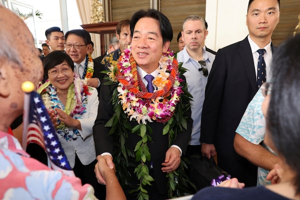 Taiwan President Lai Ching-te, center, greets people at the Kahala Hotel and Resort Saturday, Nov. 30, 2024 in Honolulu. (AP Photo/Marco Garcia)