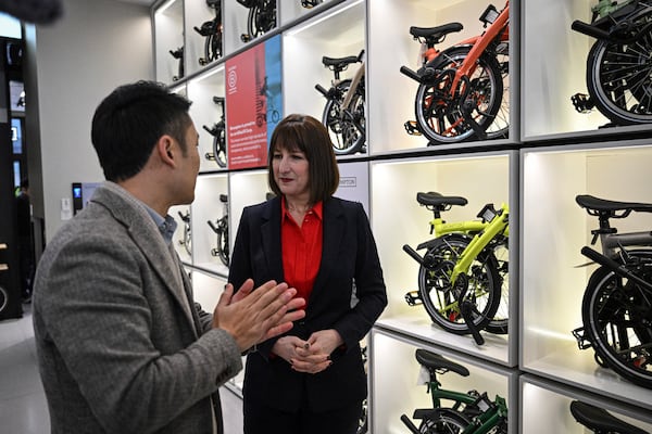 Britain's Chancellor of the Exchequer Rachel Reeves, right, visits a Brompton flagship store in Beijing, Saturday, Jan. 11, 2025. (Jade Gao/Pool Photo via AP)