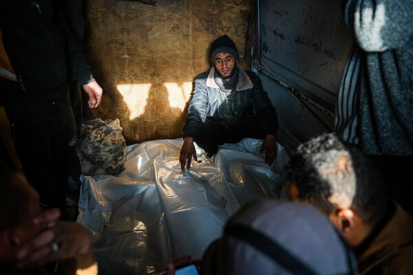 Mourners attend the funeral of three members of Imad Al-deen family who were killed in the Israeli bombardment in Bureij, central Gaza Strip, at Al-Aqsa Martyrs Hospital in Deir al-Balah, Monday, Jan. 6, 2025. (AP Photo/Abdel Kareem Hana)