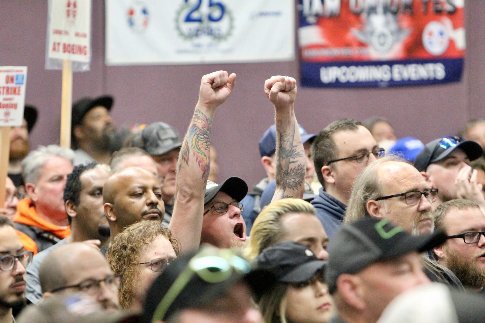 A man cheers during a rally by Boeing machinists, labor allies and elected officials at their union hall, Tuesday, Oct. 15, 2024, in Seattle. (AP Photo/Manuel Valdes)