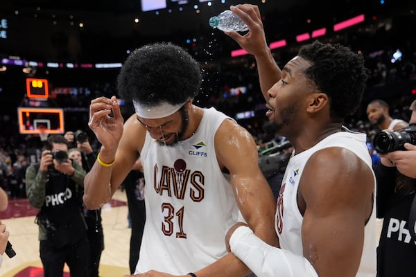 Cleveland Cavaliers guard Donovan Mitchell, right, celebrates with Jarrett Allen (31) after the Cavaliers defeated the Oklahoma City Thunder in an NBA basketball game, Wednesday, Jan. 8, 2025, in Cleveland. (AP Photo/Sue Ogrocki)