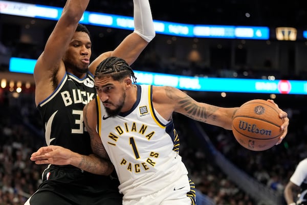 Indiana Pacers' Obi Toppin trioes to get past Milwaukee Bucks' Giannis Antetokounmpo during the second half of an Emirates NBA cup tournament basketball game Friday, Nov. 22, 2024, in Milwaukee. The Bucks won 129-117. (AP Photo/Morry Gash)