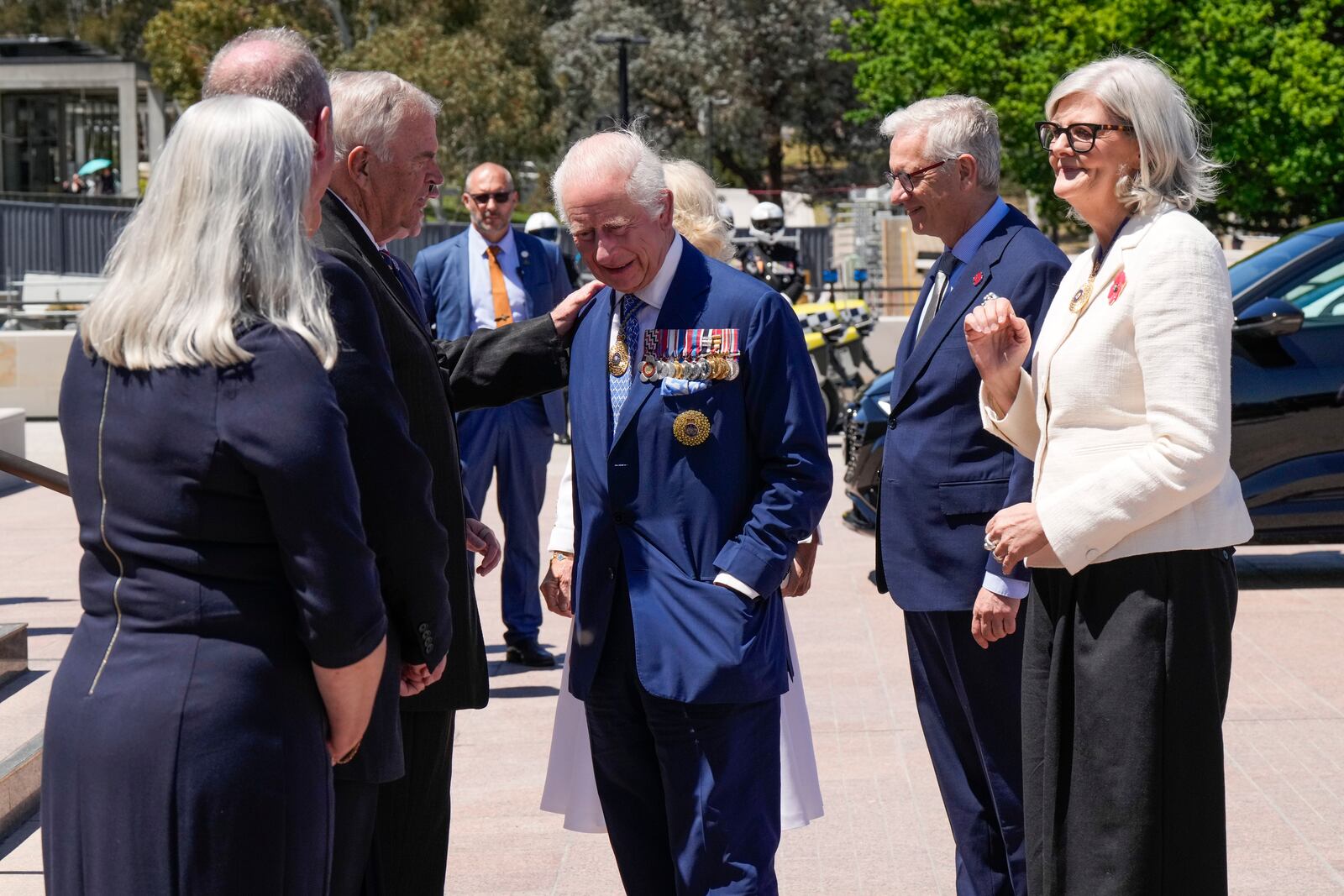 Kim Beazley, third left, chair of Australian War Memorial Council, meets Britain's King Charles III, center, on the king's arrival with Queen Camilla, partially seen at rear center, in Canberra, Australia, Monday, Oct. 21, 2024.