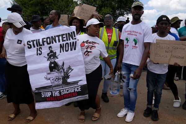 Families of miners and activist protest as South Africa's Police minister Senzo Mchunu visit an abandoned gold mine, where miners are rescued from below ground in an abandoned gold mine in Stilfontein, South Africa, Tuesday, Jan. 14, 2025. (AP Photo/Themba Hadebe)