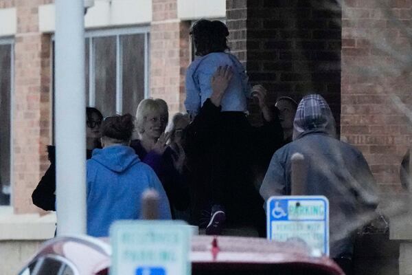 A child run to the family as they were reunited at the reunification center following a shooting at the Abundant Life Christian School, Monday, Dec. 16, 2024. (AP Photo/Morry Gash)