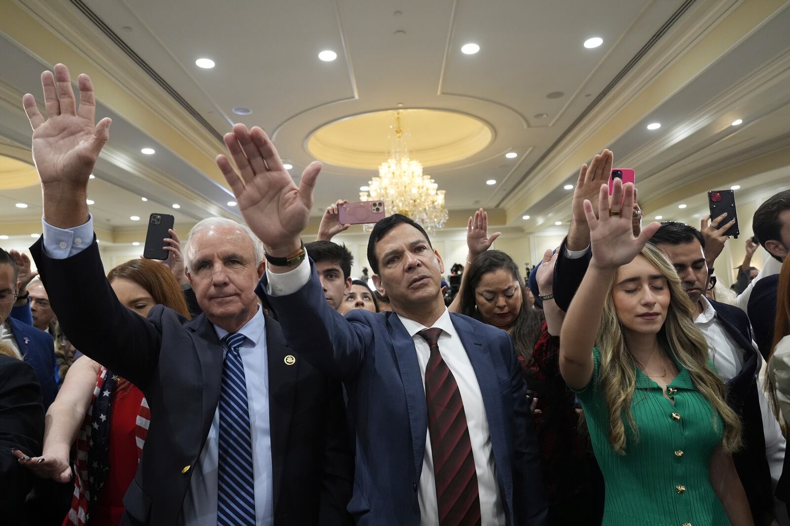 Participants pray for Republican presidential nominee former President Donald Trump during a roundtable with Latino leaders, Tuesday, Oct. 22, 2024 in Doral, Fla. (AP Photo/Alex Brandon)