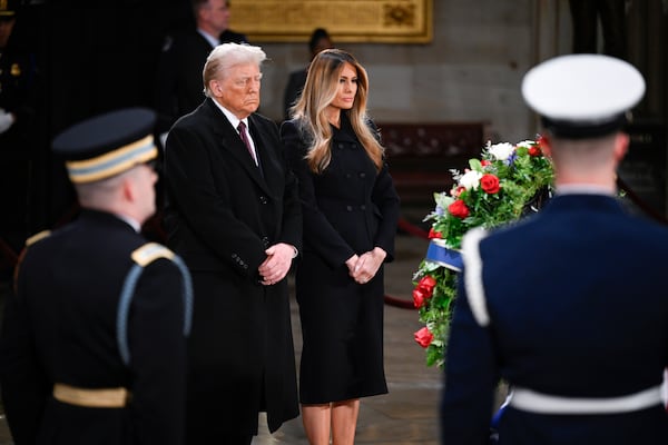 President elect Donald Trump and his wife Melania Trump visit the flag draped casket of the late former President Jimmy Carter as he lies in state at the Rotunda of the U.S. Capitol on Wednesday, Jan. 8, 2025, in Washington. (AP Photo/John McDonnell)