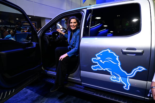 Michigan Gov. Gretchen Whitmer sits in a limited edition Detroit Lions F-150 Hybrid at the Detroit Auto Show, Wednesday, Jan. 15, 2025, in Detroit. (AP Photo/Jose Juarez)