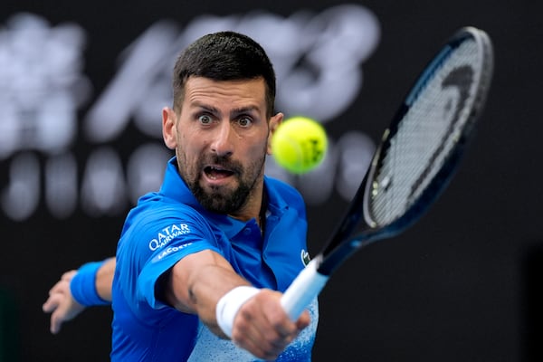 Novak Djokovic of Serbia returns a shot from Jiri Lehecka of the Czech Republic during their fourth round match at the Australian Open tennis championship in Melbourne, Australia, Sunday, Jan. 19, 2025. (AP Photo/Asanka Brendon Ratnayake)