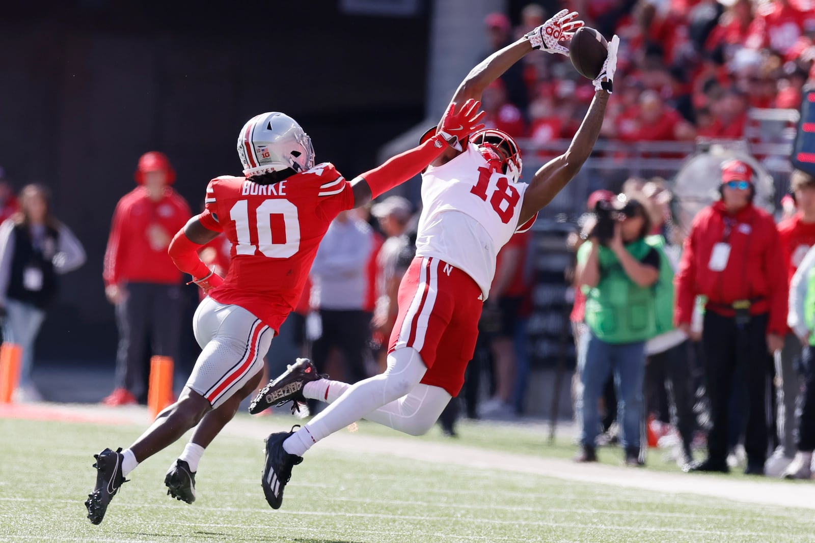 Nebraska receiver Isaiah Neyor, right, tries to catch a pass over Ohio State defensive back Denzel Burke during the first half of an NCAA college football game Saturday, Oct. 26, 2024, in Columbus, Ohio. (AP Photo/Jay LaPrete)