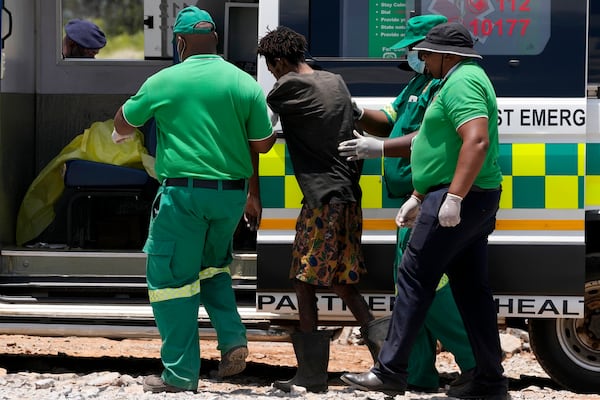 Rescuer workers assist an illegal miner who has been trapped deep in an abandoned gold mine for months, in Stilfontein, South Africa, Tuesday, Jan. 14, 2025. (AP Photo/Themba Hadebe)