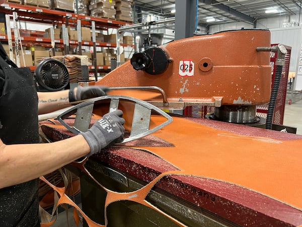 An employee uses a machine that cuts the material into a shape of a football for the upcoming Super Bowl matchup between the Philadelphia Eagles and the Kansas City Chiefs at the Wilson Sporting Goods football factory, Monday, January 27, 2025, in Ada, Ohio. (AP Photo/Patrick Aftoora-Orsagos)