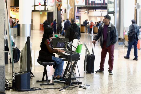 Roz McCommon performs at Seattle-Tacoma International Airport on November 26, 2024, in SeaTac, Wash. (AP Photo/Manuel Valdes)