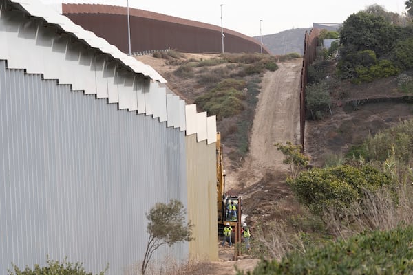 Construction crews replace sections of one of two border walls separating Mexico from the United States, Wednesday, Jan. 22, 2025, in Tijuana, Mexico. (AP Photo/Gregory Bull)